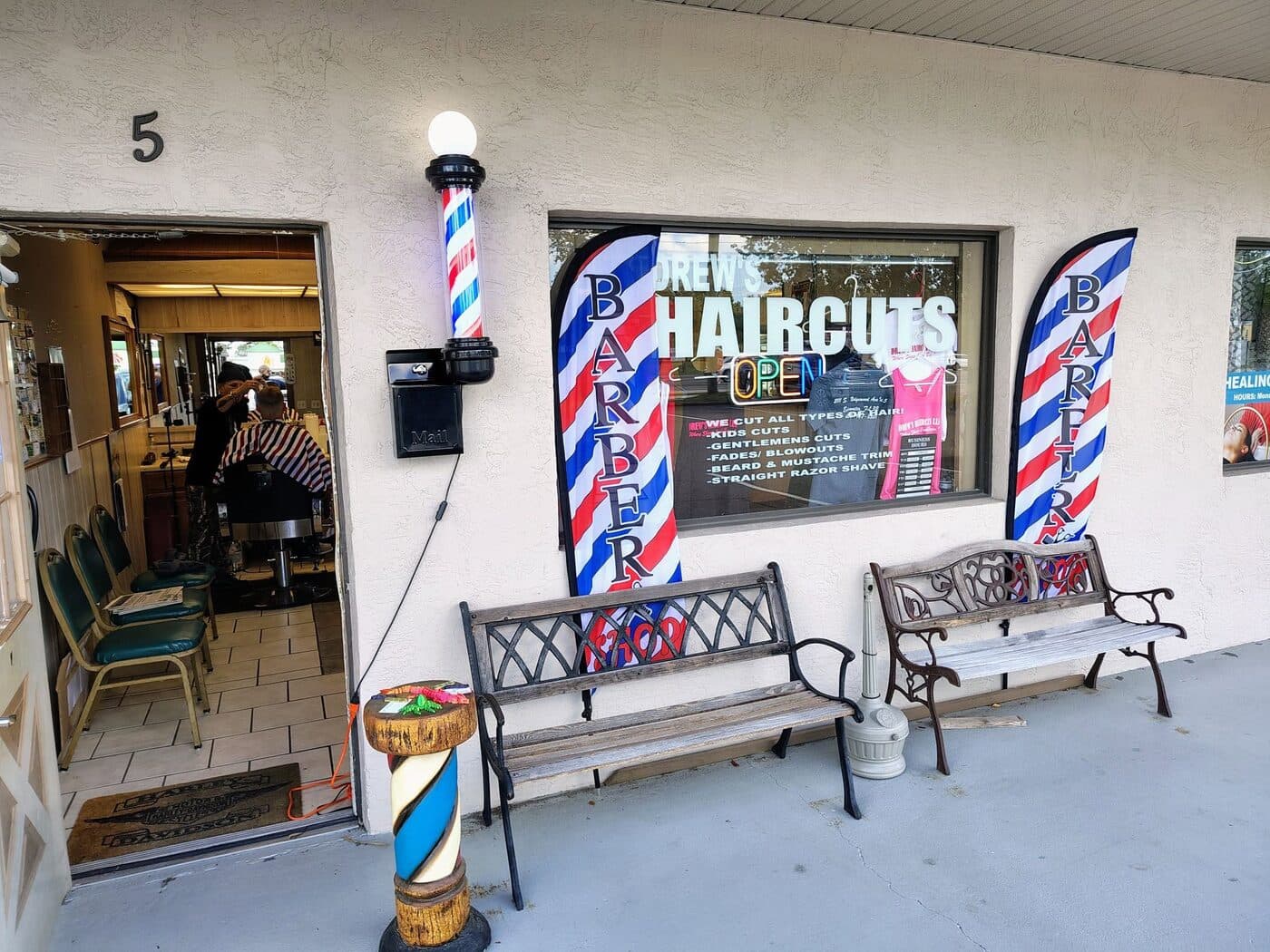 Drew's Haircuts LLC storefront with barber poles